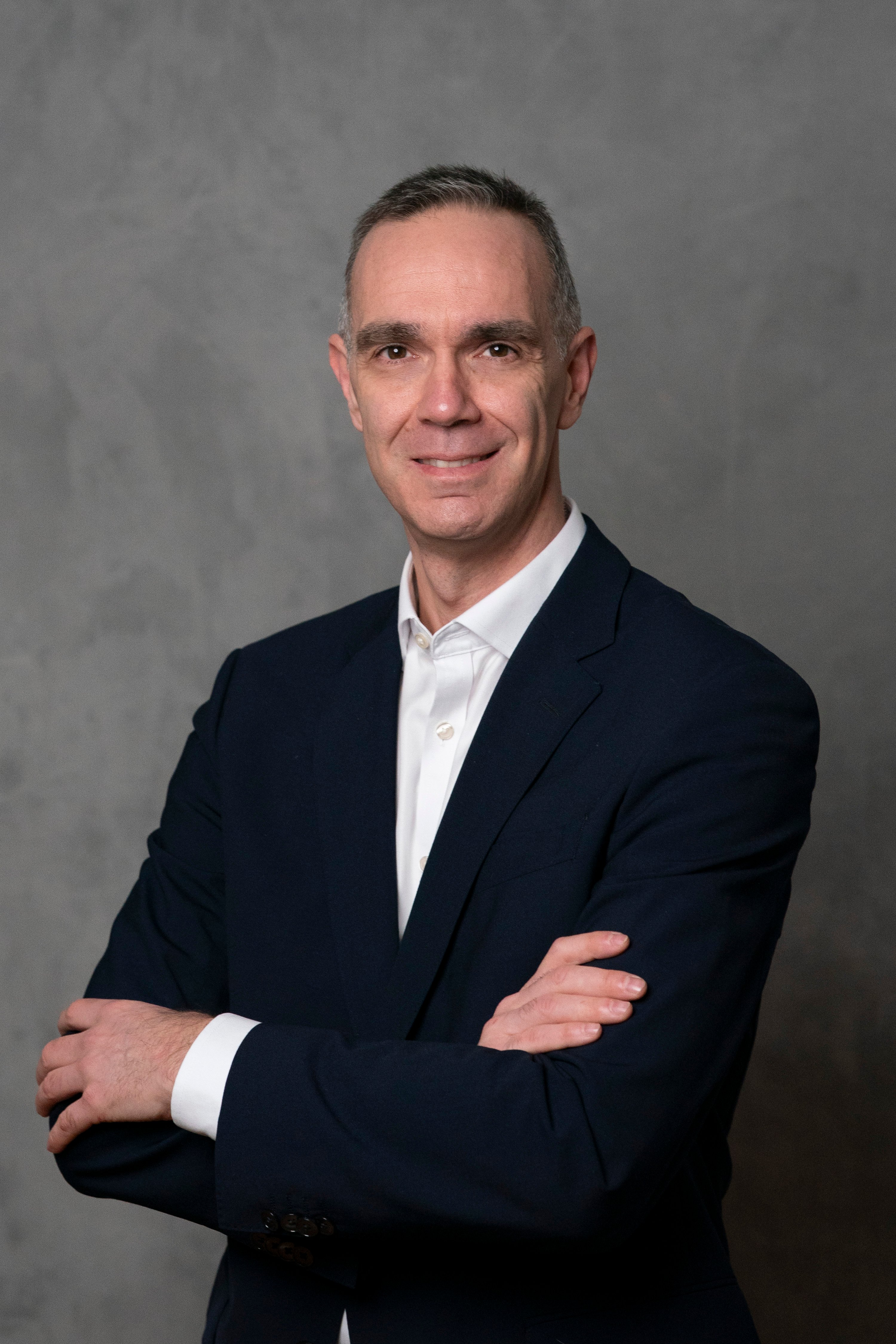 Man in suit with his arms crossed.